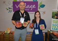 Andrew Sable and Avery LeFils with Village Farms show different tomato varieties and packaging.